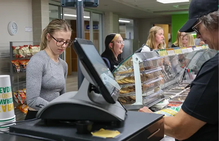 students check out at subway